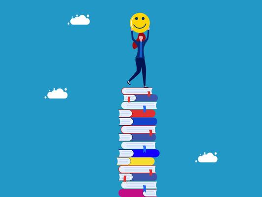 a person standing on top of a stack of books with a smiley face