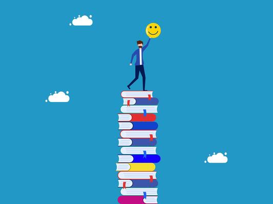 businessman standing on top of stack of books with smiley face