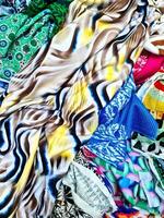 Colorful fabrics showing various patterns and textures creating an abstract composition photo