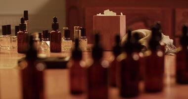 Different bottles placed on table in perfume lab video