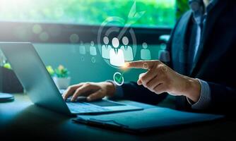 Businessman Selecting Target Audience Using Digital Touchscreen with Virtual Icons Representing Marketing, Recruitment, Customer Relationship Management photo