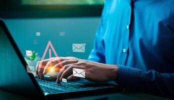 Cybersecurity Email Threat Concept with Businessman Receiving Fraudulent Messages, Highlighting Spam, Phishing Attacks, and Online Data Security Risks on Laptop, viruses, junk mail, scams photo