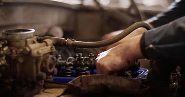 Man assembling engine of car video