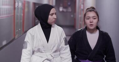 Diverse fighters walking in hallway and chatting video