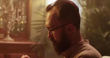 Male perfumer smelling aromatic oil while creating perfume video