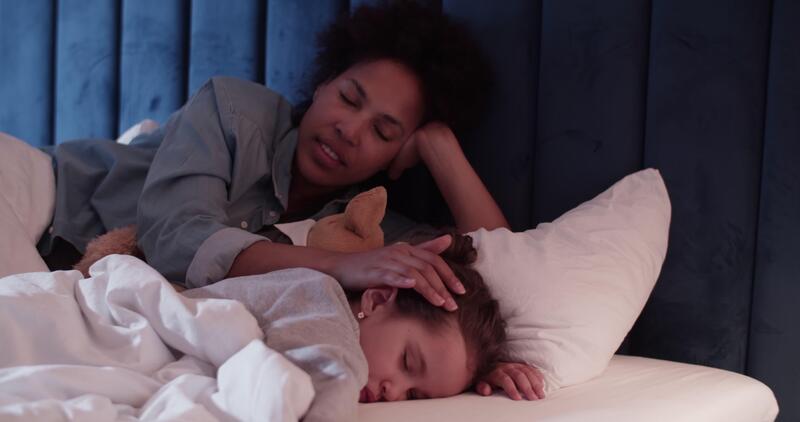 Mother caressing sleeping daughter at night 56488018 Stock ...