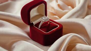 Luxurious Diamond Engagement Ring in an Open Red Velvet Box with Satin Fabric and Rose Petals for a Romantic Proposal photo