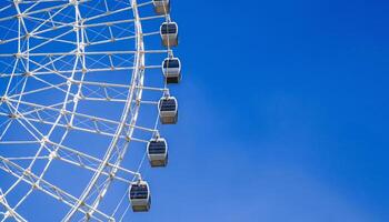 white big ferris wheel on background clear blue sky in Park with copy space photo