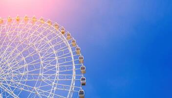 white ferris wheel on background clear blue sky in Navruz Park in Tashkent with copy space photo