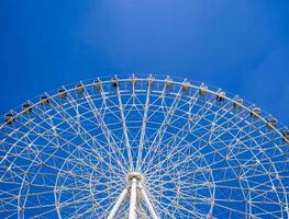 white big Ferris wheel on background a clear blue sky in amusement Navryz park in Tashkent in summer with copy space photo