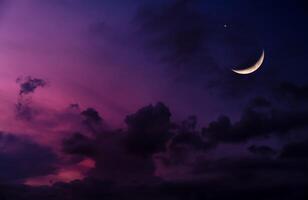 Ramadan Crescent Moon ushering in a Holy Month,Eid Mubarak Background,Night sky dark purple sky,cloudy with Waxing Crescent Moon.Concept for beginning of the month in the lunar Islamic calendar photo