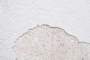 White Paint peel off, Broekn cracking concrete wall interior, Old Grey wall building construction with torn texture.Outdoor architecture with grunge plaster peeling. Cement floor with grain surface photo