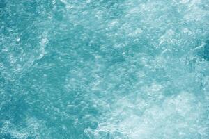 Abstract transparent water texture, bubbling clear water as textured background, purity and beauty of nature, natural ripples and waves on turquoise aquatic surface, nature environment photo