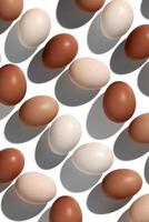 Pattern of Brown and White Egg with shadows, minimal style aesthetic holiday background, isolated natural organic chicken eggs, breakfast ingredients, minimalist food composition, neutral color photo