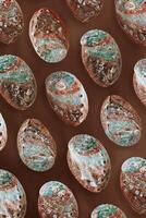 Minimal style marine pattern, shiny abalone shells, aesthetic top view background with natural textured oceanic seashells, vivid color abstract summer flat lay, sea and ocean beauty and nature photo