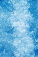 Abstract transparent water texture, bubbling clear water as textured background, purity and beauty of nature, natural ripples and waves on blue aquatic surface, nature environment photo