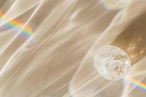 Quartz Prism's Rainbow Reflection at sunlight, close up of clear quartz crystal captures prismatic rainbow, natural facets and beauty of mineral. Minimal aesthetic nature pattern, beige pastel tone photo