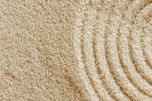 Top view pattern in Japanese Zen Garden with close up concentric circles on sand for meditation and relaxation. Aesthetic minimal sandy background with copy space, beige monochrome neutral tones photo
