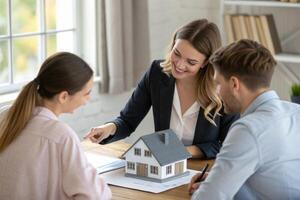 Real estate agent discussing property with young caucasian couple photo