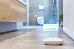 Smart bathroom sensor on modern bathroom floor for home automation and safety photo