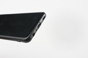 Black Smartphone Close-Up Highlighting Type C Charger Port and Headphone Jack photo