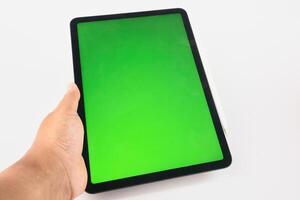 Hand Holding Tablet with Green Screen Display and Stylus Attached photo