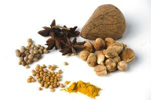 Whole Spices Including Star Anise, Pepper, Turmeric Powder, Kluwak or Kluwek and Coriander on a White background photo