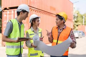 Construction professionals discussing blueprints and site plans while collaborating at a project location photo