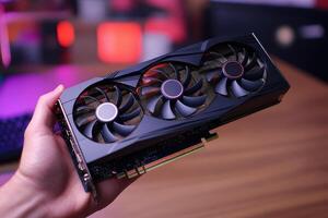 Technician holding powerful new graphics card for desktop computer photo