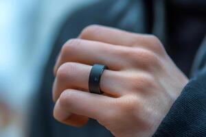 Man wearing smart ring showing temperature reading on finger photo