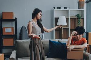 A woman is holding a box while a man is standing next to her photo