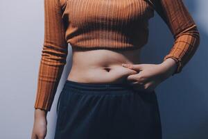 A woman with a flat stomach and a large belly photo