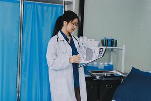 A woman in a lab coat is standing in front of a bed photo