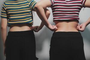 Two women in striped tops standing next to each other photo