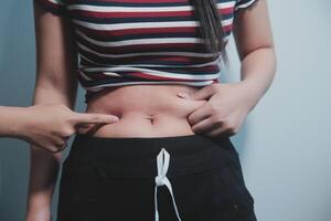 A woman is showing off her stomach photo