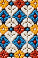 Intricate Indigenous beadwork showcasing vibrant craftsmanship with geometric patterns in red, blue, and yellow tones photo