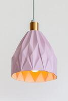 Lavender-colored modern pendant lamp with geometric design enhancing contemporary decor in a soft pastel setting photo