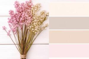 Harmonious pastel color palette featuring pink, beige, and gray swatches alongside dried flowers in an elegant modern setting photo