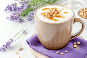 Close-up view of a rich latte with golden caramel drizzle in a mocha brown cup, nestled on a cozy lavender napkin with lavender flowers nearby photo