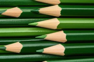 Collection of sharp green pencils lined up with smooth wooden texture for artistic expression and creativity photo