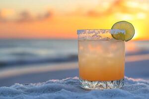 Refreshing margarita cocktail standing on the beach during sunset photo