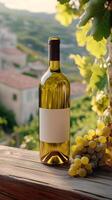 Bottle of white wine resting on a wooden surface with grapes and vineyards in the background photo
