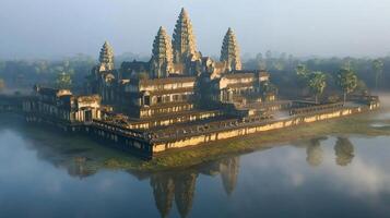 Angkor Wat reflecting in the water during sunrise in Cambodia photo