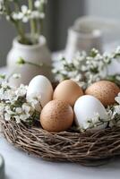 Easter eggs nestled in a bird's nest with spring flowers creating a festive centerpiece photo