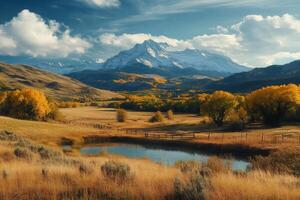 Crested Butte mountain towering over autumn foliage and reflecting in pond photo