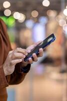 Detailed view of a hand interacting with a smartphone in a modern setting, showcasing technology in everyday life. photo