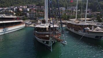 Aerial. a group of sailing yachts is moored in the harbor of the city of Fethi video