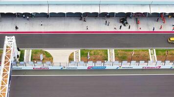 Aerial view of Mandalika Circuit pit lane with vintage car in Lombok video