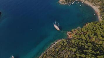 View from drone to a large sailing ship standing anchored in a beautiful bay video