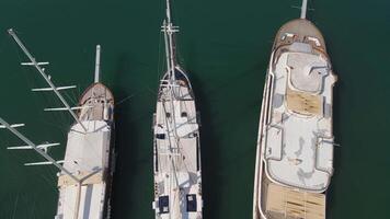 View from top to bottom on the decks of moored sailing yachts video